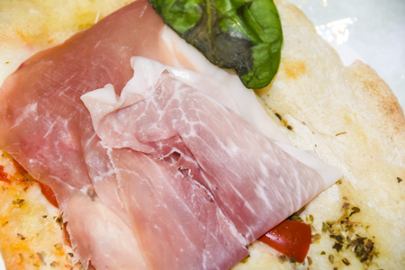 Antipasti prosciutto basil mozzarella tomatoes cheeseの写真素材