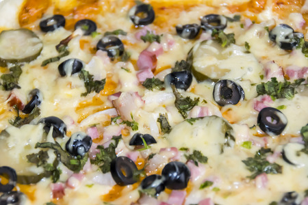 background pizza with olives, cucumbers and black olives, lots of cheeseの写真素材