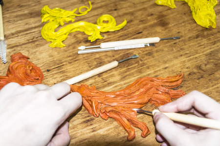 artist's Hands cut and modeling of animal figures of clay and plasticine instrumentsの写真素材
