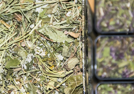packing with dry green herbal tea on  wooden backgroundの写真素材
