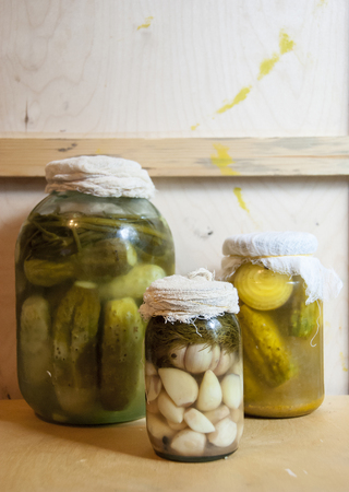 Assortie Jars of Marinated vegetables picles tomato on a wooden backgroundの写真素材