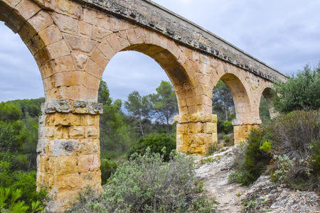 aqueduct bridge in the mountains high green landscape sky cloudsの写真素材