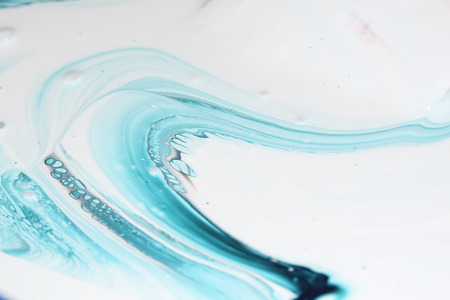 flow of blue paint on a white background abstract  colored backgroundの写真素材