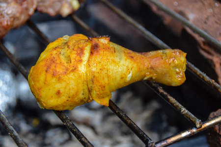 yellow marinated grilled chicken legs and outdoor bbq meat