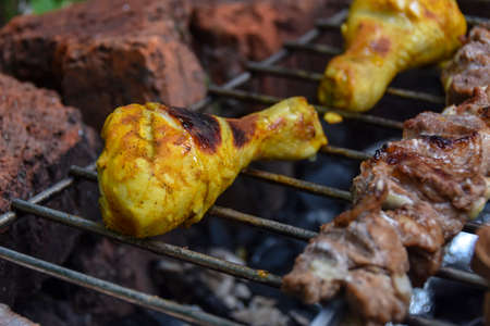 yellow marinated grilled chicken legs and outdoor bbq meatの写真素材