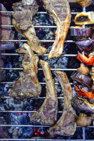 lamb ribs on the grill on a fire on a wire rack in the fresh air