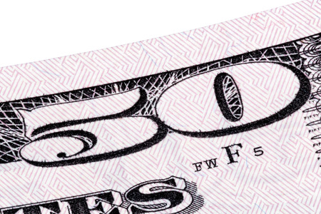 Macro stacked shot with detail of fifty dollar bill, isolated.
