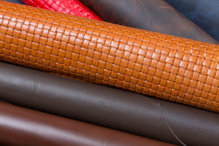 Close up of many multicolored leather pieces for sale.