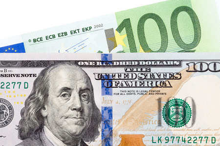 Banknotes of 100 euro and dollar on white background. High resolution photo.の写真素材