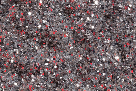 Bright grey background with red spangles. High resolution photo.