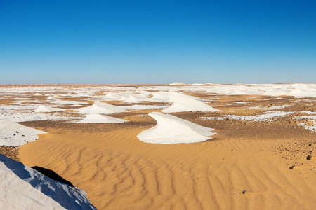 Beautiful White Desert with a contrast blue skyの写真素材