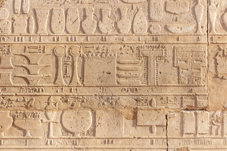 Egyptian engraved figures on the ancient wall