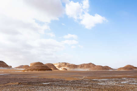 Landscape of the Red Desert with a blue cloudy sky.の写真素材