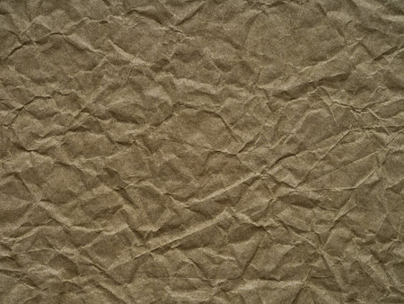 Khaki or olive color crumpled paper texture. Blank grunge page or sheet for interior and exterior decoration. Empty background for handcrafts, xmas designs decoration, text, lettering, screen saver.の写真素材