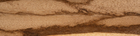 A close up of a piece of antique wooden surface. Panoramic wood veneer texture.
