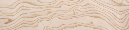 Flowing contours of plywood waves in a delicate dance of light and shadow across this plywood veneer