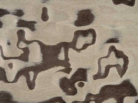 Abstract artistry on a veneer surface with a blend of taupe and espresso swirls