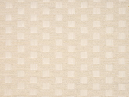 Soft beige and white square pattern on a textured wooden veneer surface