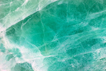 Green Fluorite. Gemstone background. Matt natural semi precious mineral pattern. Semiprecious stone texture, ceramic wall, floor digital tiles. Material for unique interior, exterior design decorationの写真素材