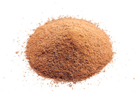 ground cinnamon pile on whiteの写真素材