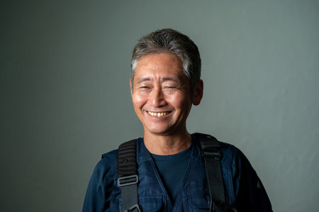 Portrait of happy senior Asian man with backpack looking at camera.の写真素材