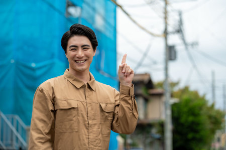 Young handsome Asian businessman thinking and pointing to the side at the cityの写真素材