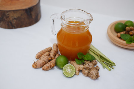 Ginger juice and fresh ginger on white background. Healthy drink.