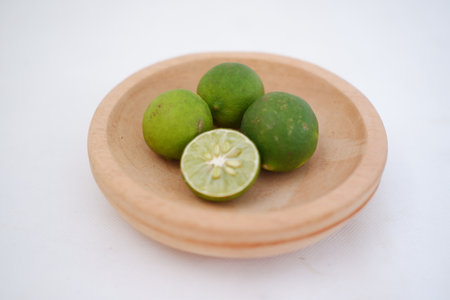 Green lime with cut in half and slices isolated on white background.の写真素材