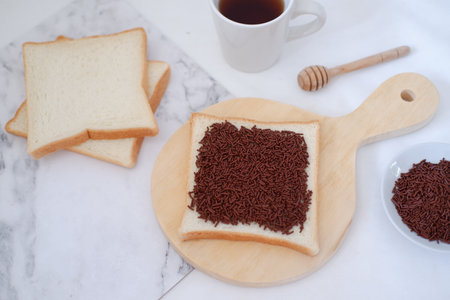 Breakfast with coffee, bread and chocolate on a white background.の写真素材