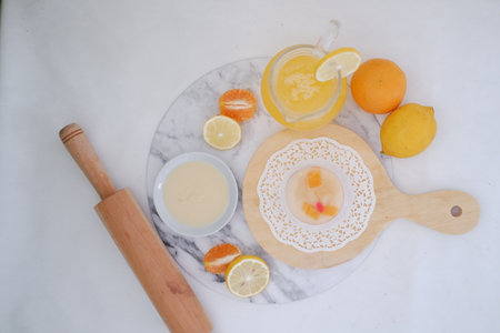 Lemonade with lemon and orange on white marble table, top viewの写真素材