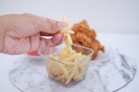 French fries and deep fried chicken on white marble background. Selective focus.の写真素材