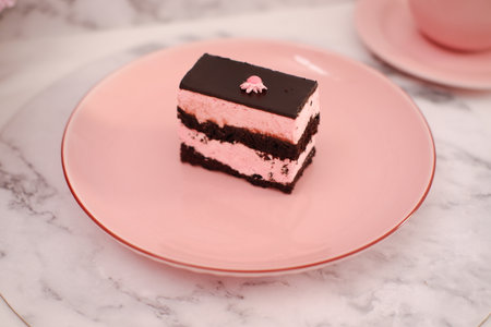 Piece of chocolate cake on a pink plate, close-upの写真素材