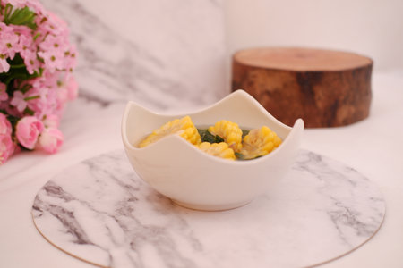 Sayur Bening Daun kelor jagung or Moringa Oleifera clear soup with sweet corn served in bowlの写真素材