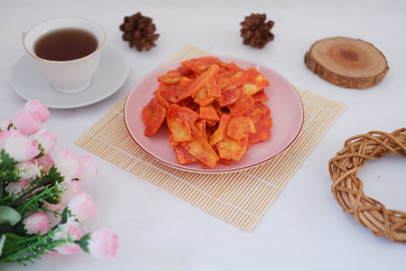 Keripik singkong balado or balado cassava chips on a serving plate, it tastes spicy, sweet and crunchyの写真素材