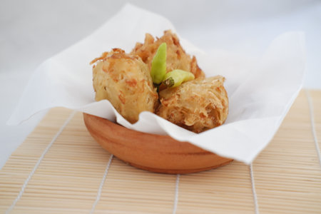 Bakwan sayur or vegetable fritter, Indonesian snack made from flour, cabbage, carrots and bean sprouts, served with chiliの写真素材