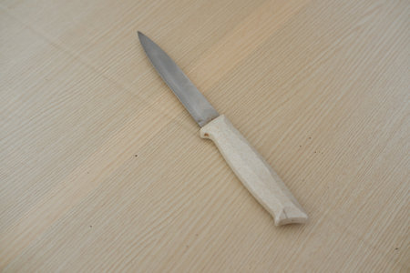 Kitchen knife on a wooden table. Kitchen utensils.