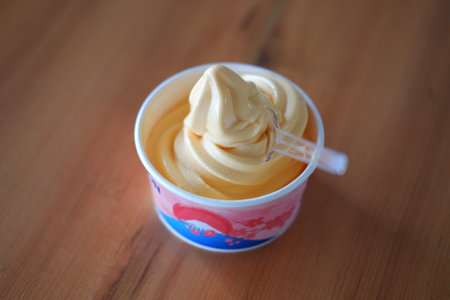 ice cream in paper cup on wood table background. soft focus.の写真素材