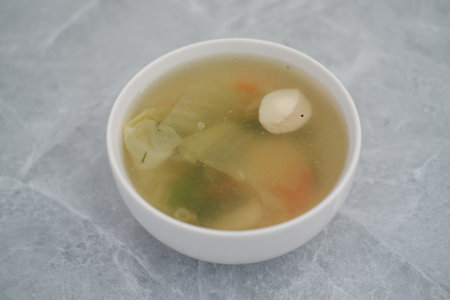 A bowl of soup on a wooden table