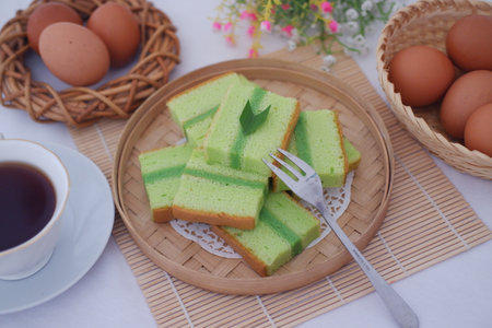 pandan cake on a wooden plate. Selective focus.の写真素材