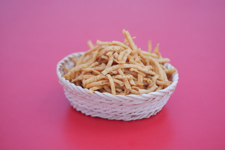 potato sticks in a basket on red background.の写真素材