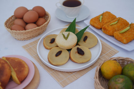 Kue Lumpur or Mud Cake, Indonesian traditional cake made from potato, flour, eggs and coconut milk topped with raisins served on white plate. beautiful decorationの写真素材