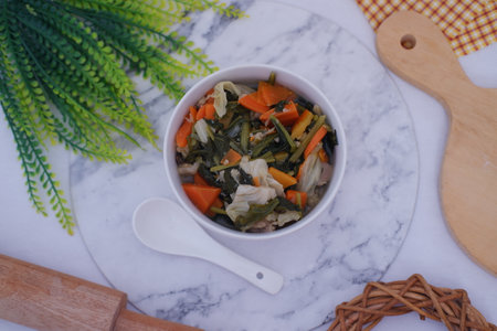 Capcay in a white bowl on a marble backgroundの写真素材