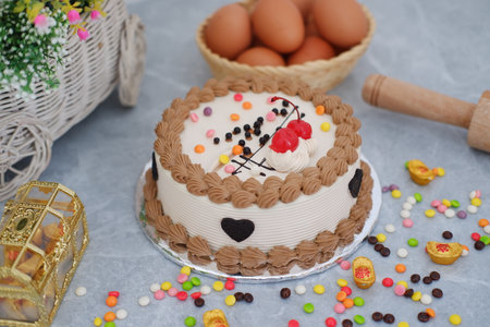 Cake with cherry on top and eggs on a marble background.の写真素材