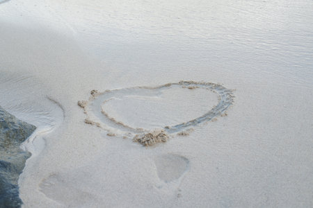 Heart drawn on the beach sandの写真素材