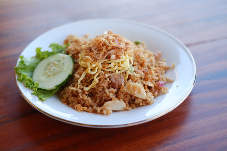 seafood fried rice with egg on wooden tableの写真素材