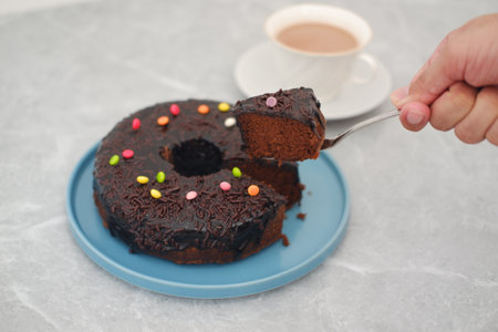 Chocolate cake on blue plate with marble tableの写真素材