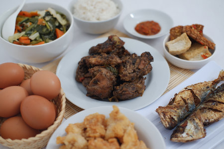 traditional Indonesian food arranged neatly on a white surfaceの写真素材