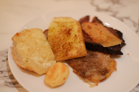 French toast with fried meat and potato chips on a white plate.の写真素材