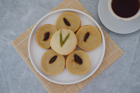 Kue Lumpur or Mud Cake, Indonesian traditional cake made from potato, flour, eggs and coconut milk topped with raisins served on plate. beautiful decorationの写真素材