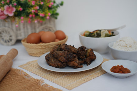traditional Indonesian food arranged neatly on a white surfaceの写真素材